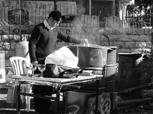 How to Prepare a Home for Pesach 1 A man stands with large containers of boiling water, ready to kasher (make kosher) untensils for Pesach use. This photo was taken in Meah Sha'arim, a religious area of Jerusalem where apartments are often small and crowded with no storage space available for utensils reserved just for Pesach use.