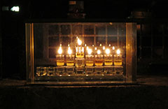 The Chanukiah 5 In Israel, many families have a chanukiah in a special protective case which they place and light on their front fence in order to publicise the miracle of Chanukah. This photo is of a chanukiah burning on 6th night Chanukah on the front fence of a Jerusalem home.